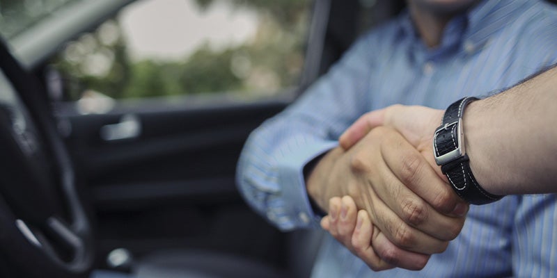 Spence Chevrolet customer shaking hands with sales rep