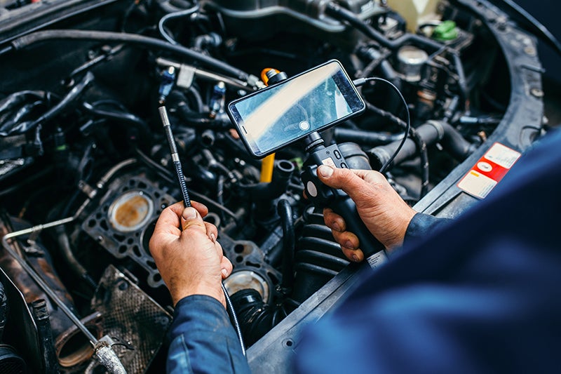 Spence Chevrolet in Thomasville GA technician working on an engine